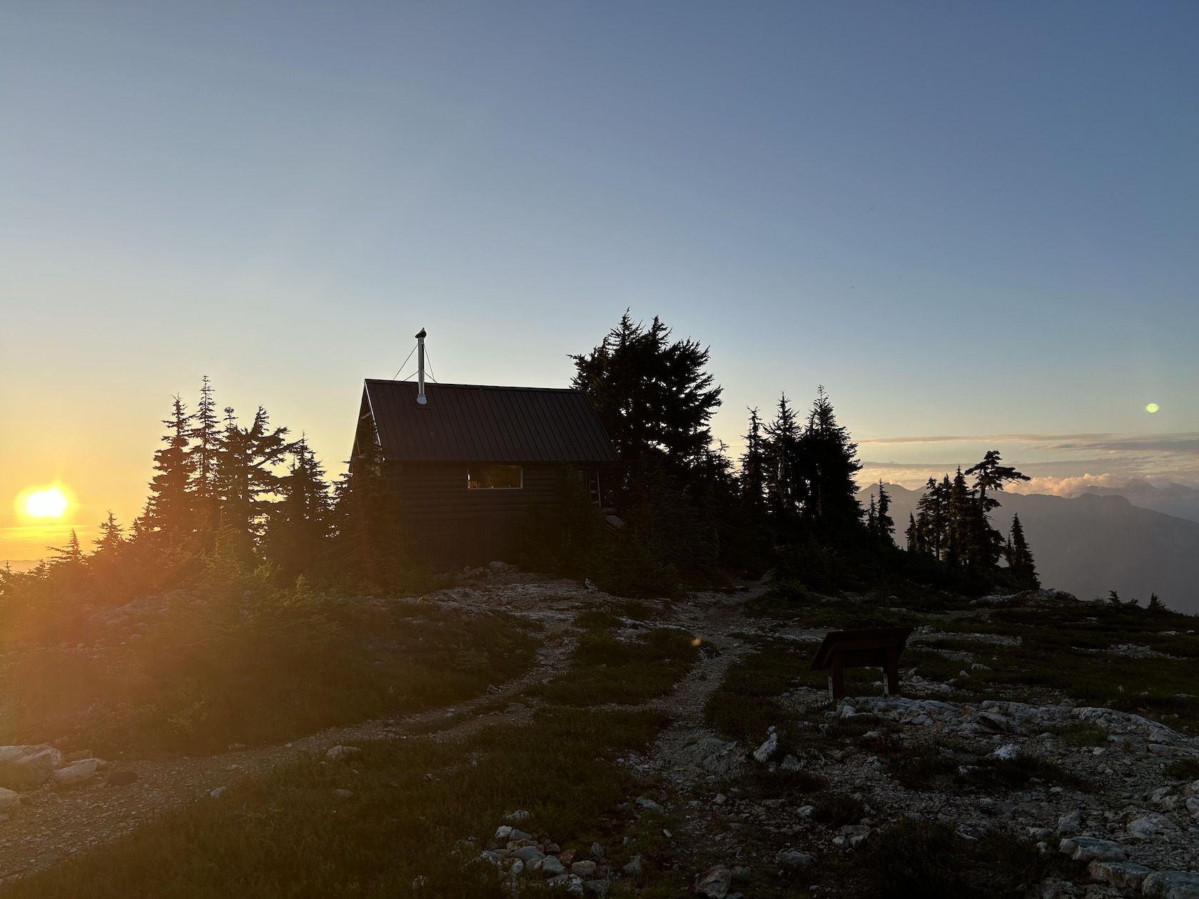 The cabin at steele mountain at sunset with the moon